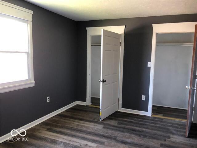 unfurnished bedroom featuring dark hardwood / wood-style flooring