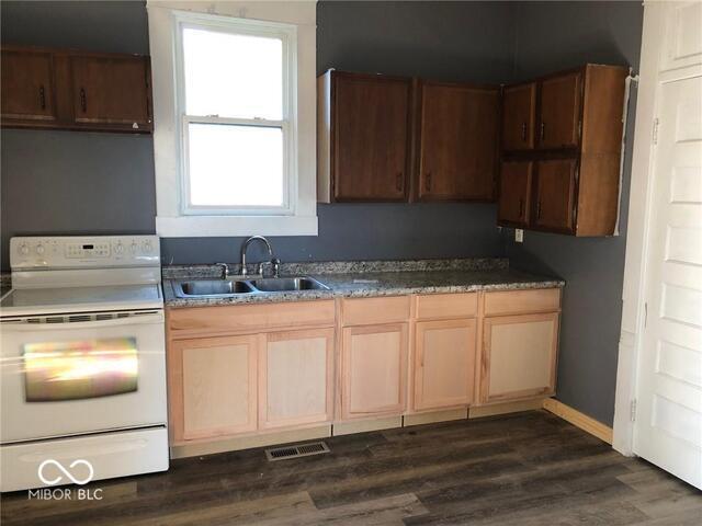 kitchen featuring white range, dark hardwood / wood-style flooring, a wealth of natural light, and sink