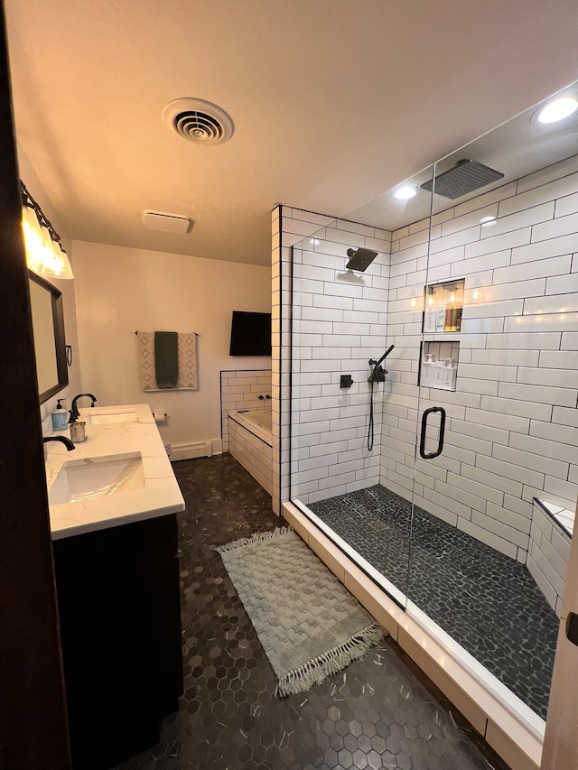 bathroom with a shower with door, tile floors, double sink, and large vanity