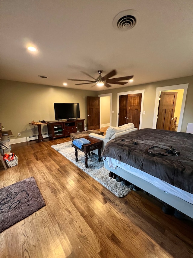 bedroom with ceiling fan and dark hardwood / wood-style flooring