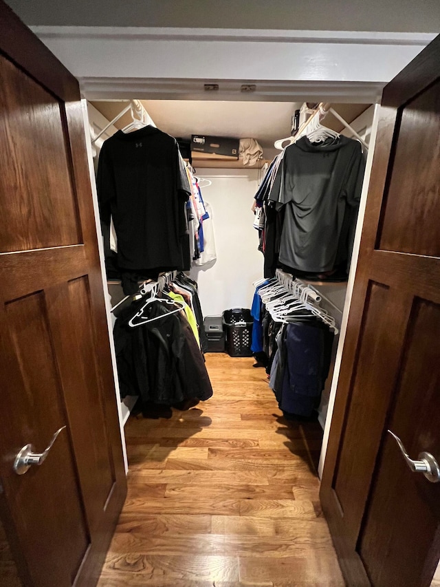 spacious closet featuring light hardwood / wood-style floors