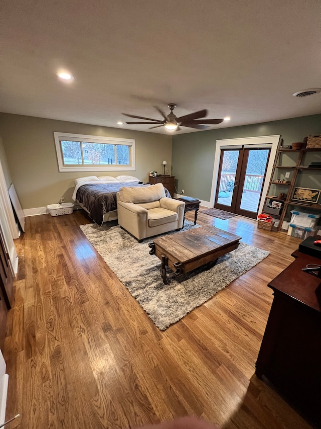 living room with hardwood / wood-style flooring, ceiling fan, and french doors