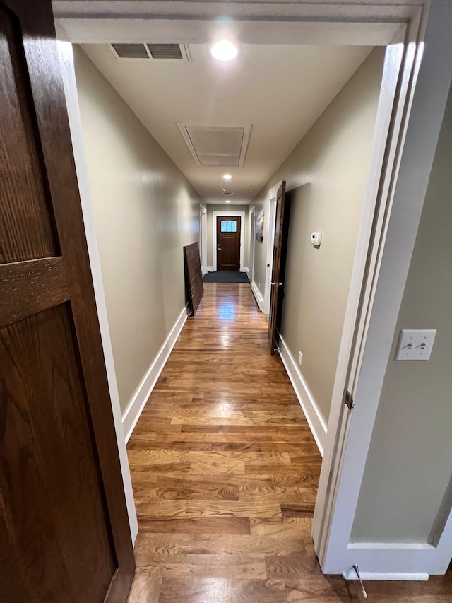 hall with light hardwood / wood-style floors