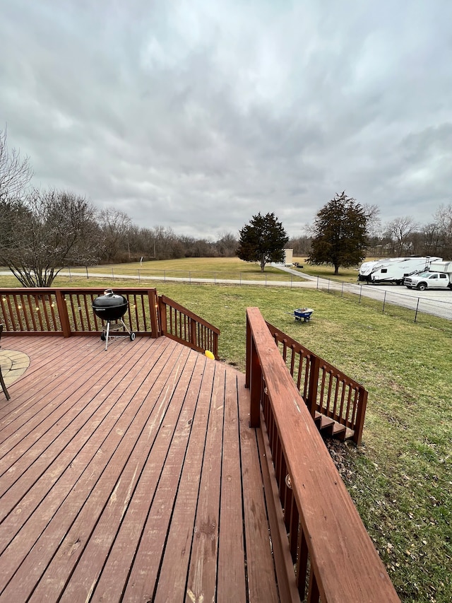 wooden terrace featuring a yard and area for grilling