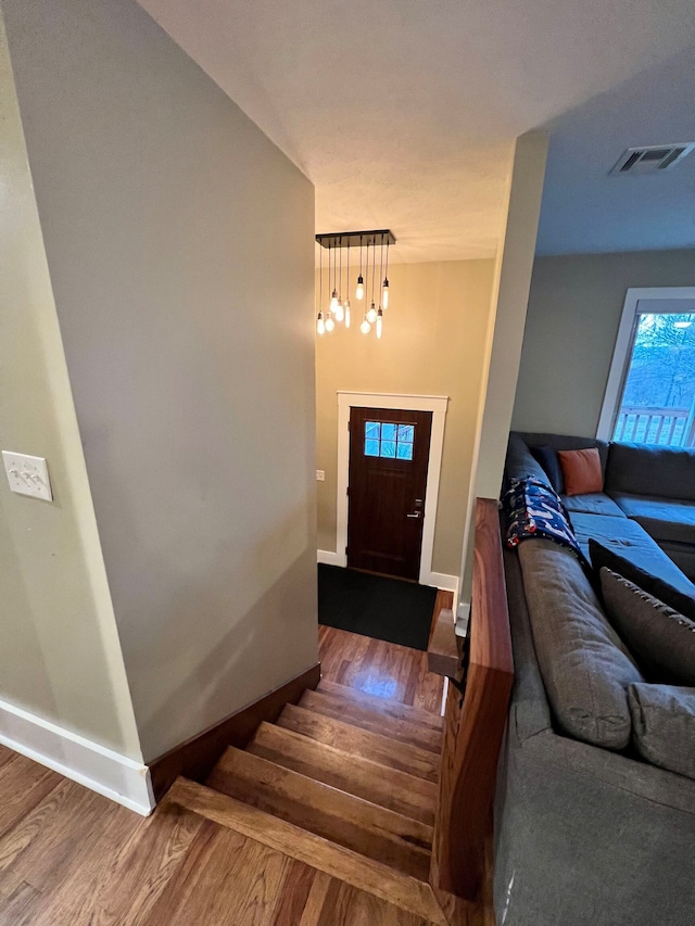 stairway with dark hardwood / wood-style flooring