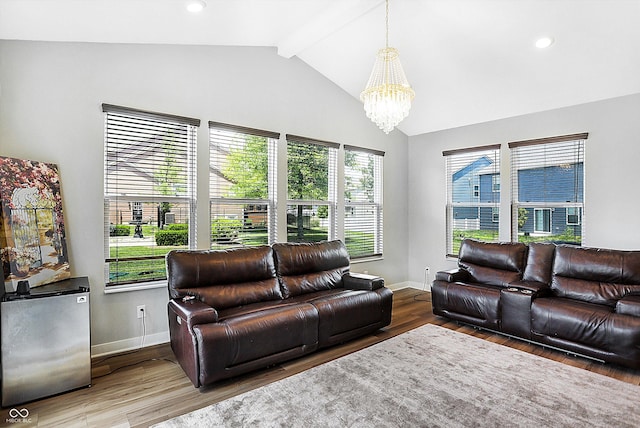 living room with a notable chandelier, hardwood / wood-style flooring, and lofted ceiling with beams