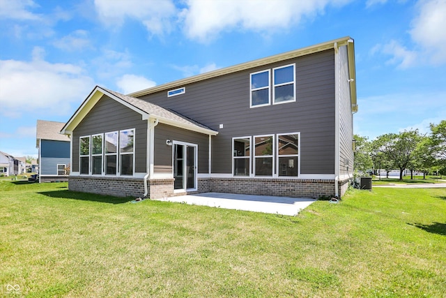 rear view of house with a yard, central AC, and a patio area