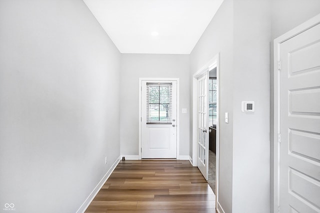 doorway with dark wood-type flooring