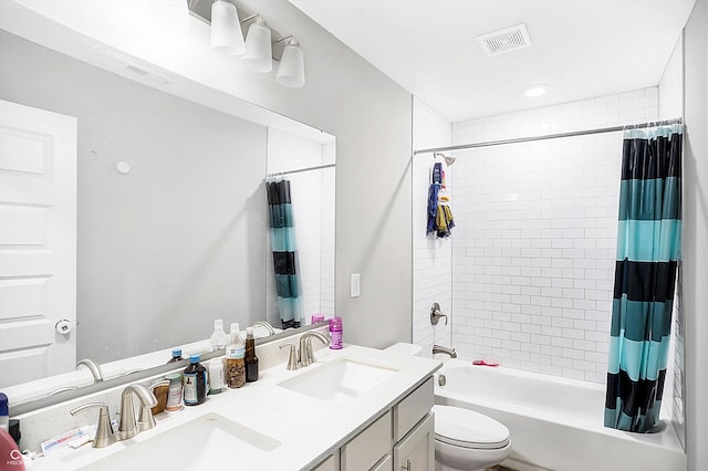 full bathroom featuring vanity, shower / bath combination with curtain, and toilet