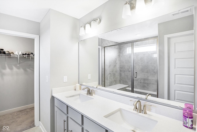 bathroom featuring vanity and a shower with shower door