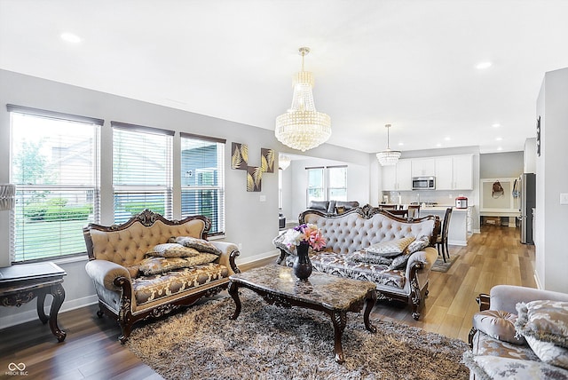 living room featuring a chandelier and light hardwood / wood-style floors