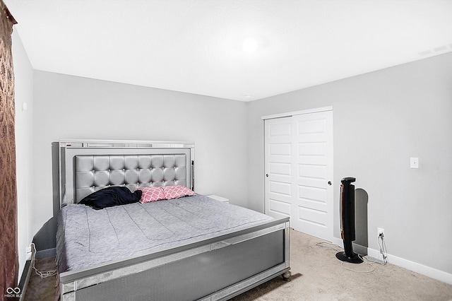 bedroom with light carpet and a closet