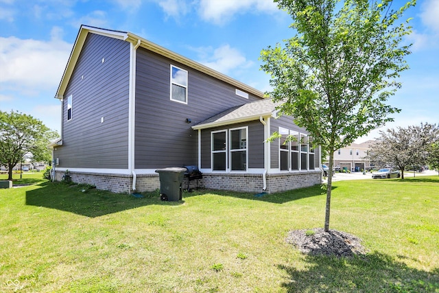 back of house with a lawn