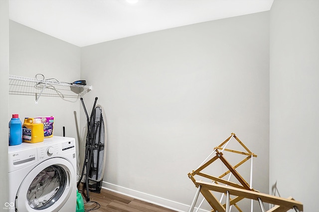 clothes washing area featuring washer / clothes dryer and hardwood / wood-style floors