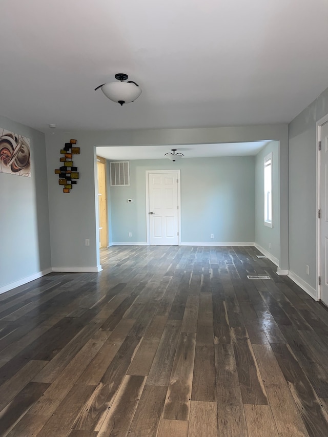 empty room with dark hardwood / wood-style floors