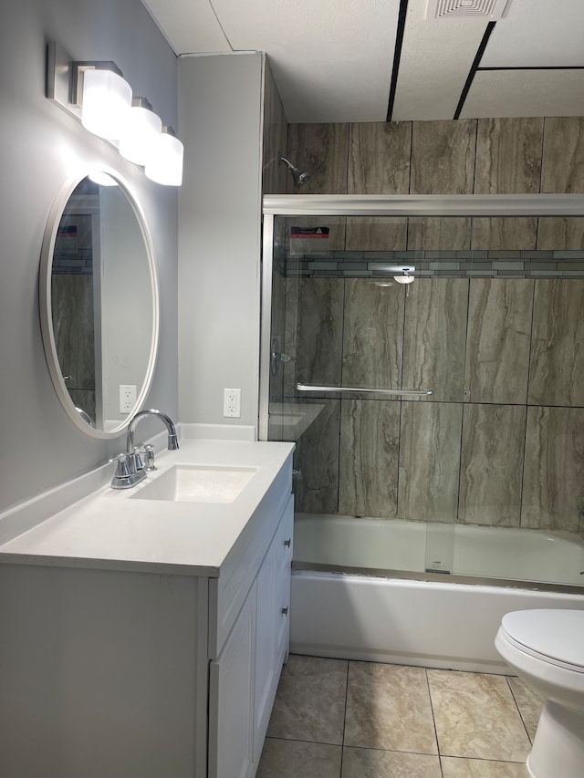 full bathroom featuring combined bath / shower with glass door, toilet, tile floors, and vanity