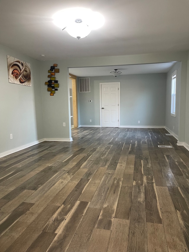 spare room with dark wood-type flooring