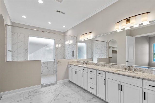 bathroom featuring an enclosed shower, vanity, and ornamental molding