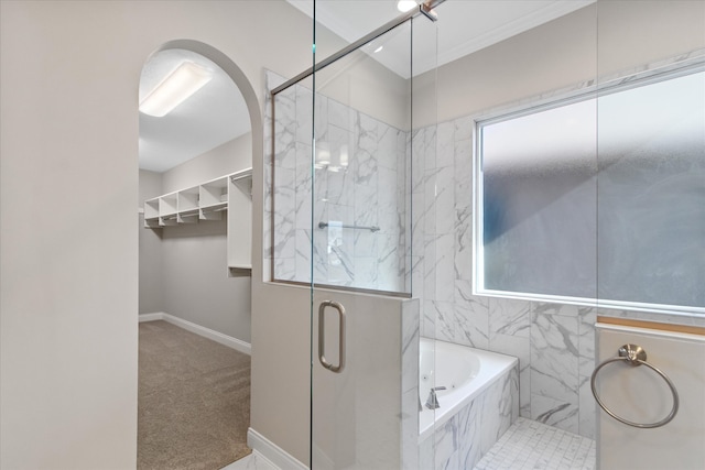 bathroom featuring shower with separate bathtub