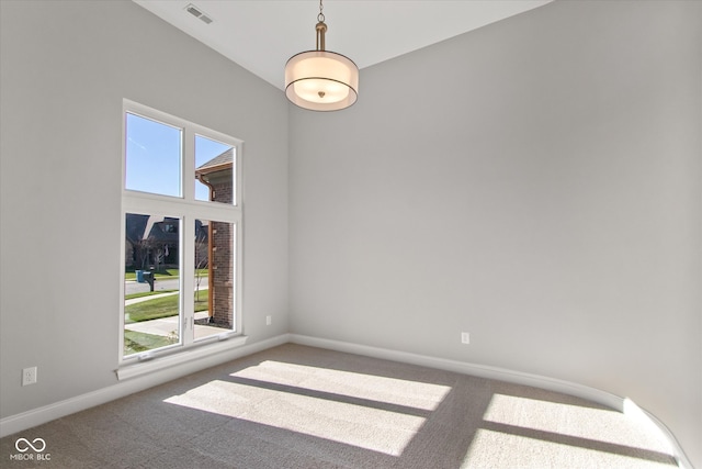 unfurnished room featuring a healthy amount of sunlight and carpet flooring