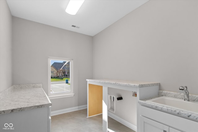 washroom featuring cabinets and sink