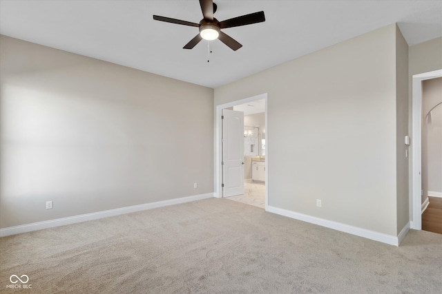 carpeted spare room with ceiling fan