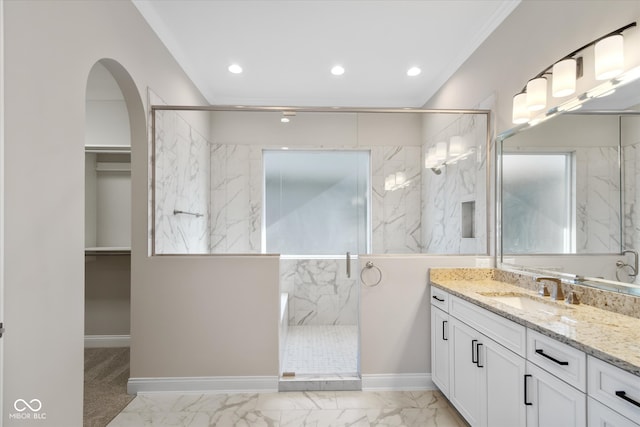 bathroom with vanity, ornamental molding, and an enclosed shower