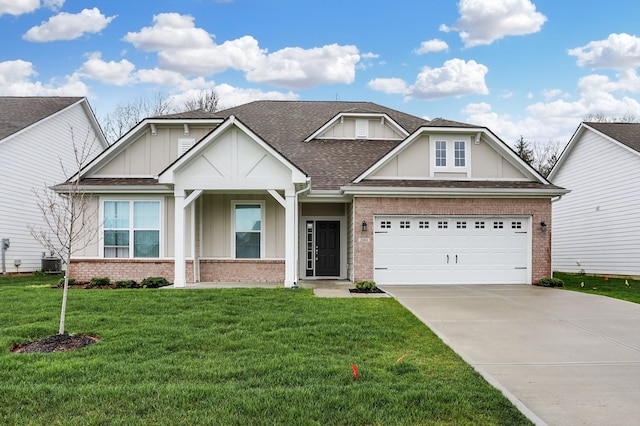 craftsman inspired home featuring a garage and a front lawn