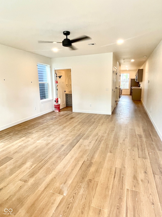 unfurnished living room featuring ceiling fan and light hardwood / wood-style flooring