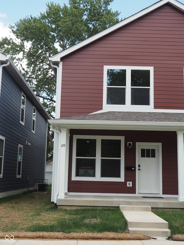 view of front of home featuring a front lawn and cooling unit