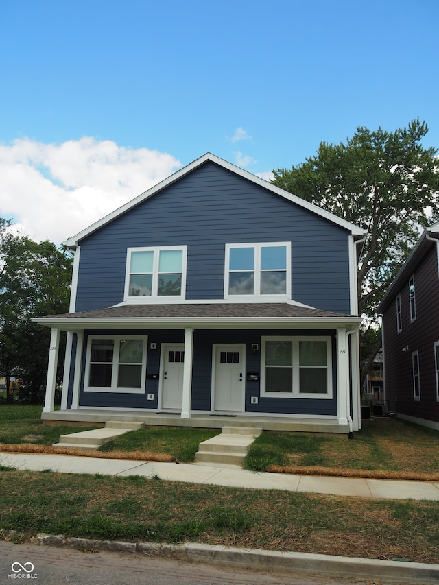 view of front of property with a front yard and covered porch