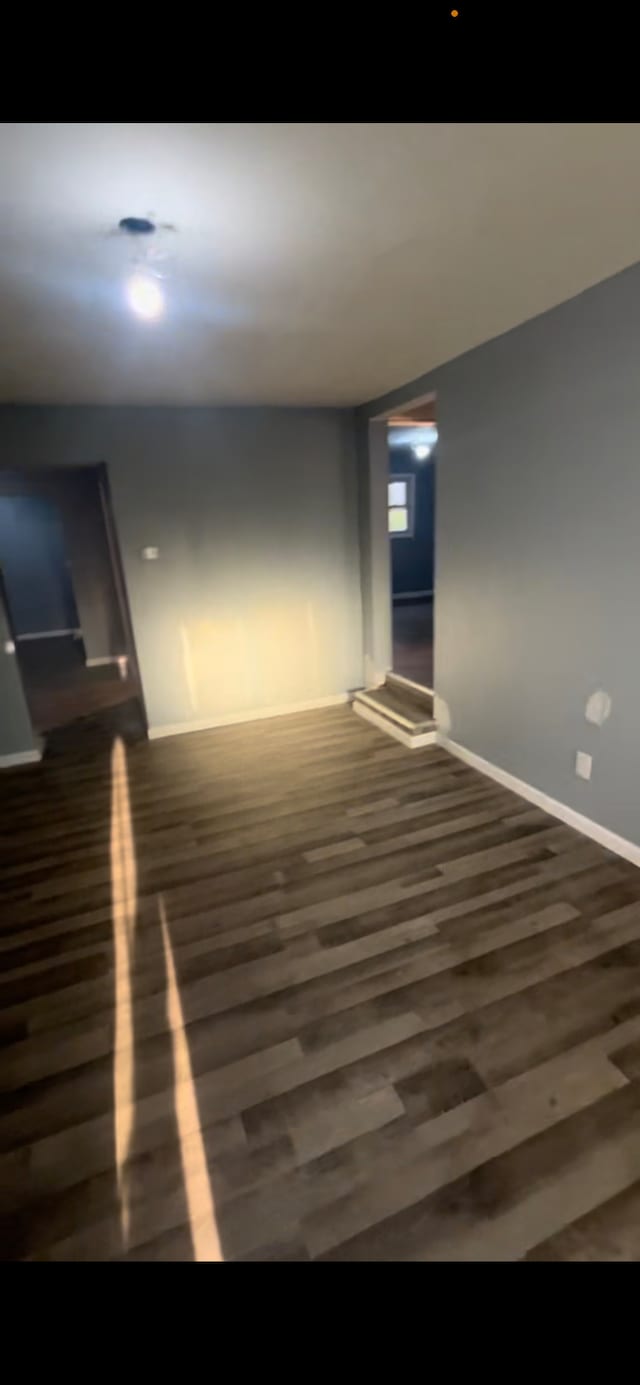 spare room with dark hardwood / wood-style floors