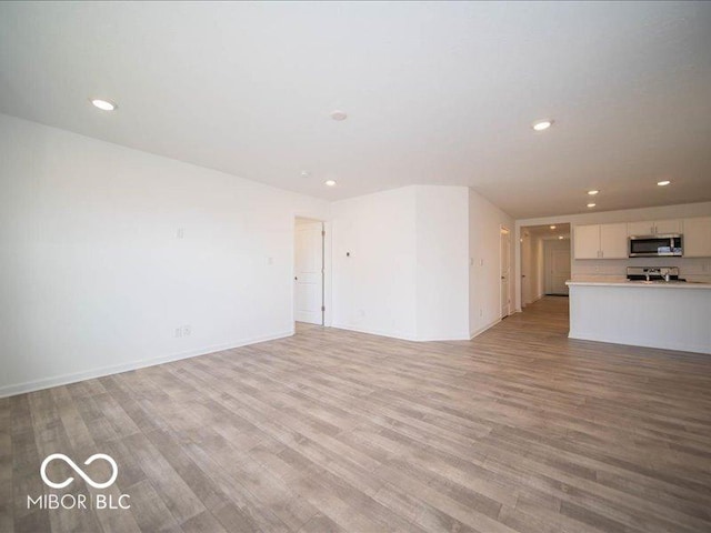 unfurnished living room featuring light wood-type flooring