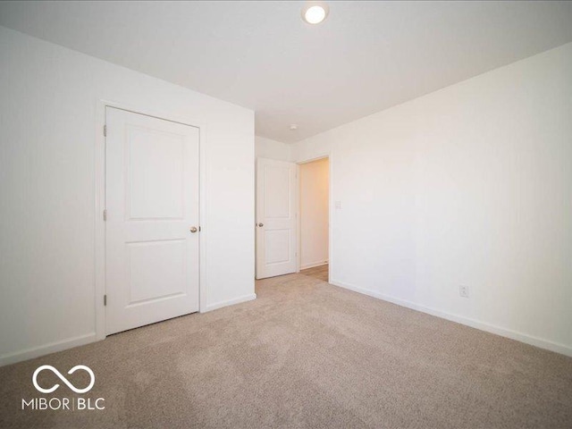 unfurnished bedroom with light carpet