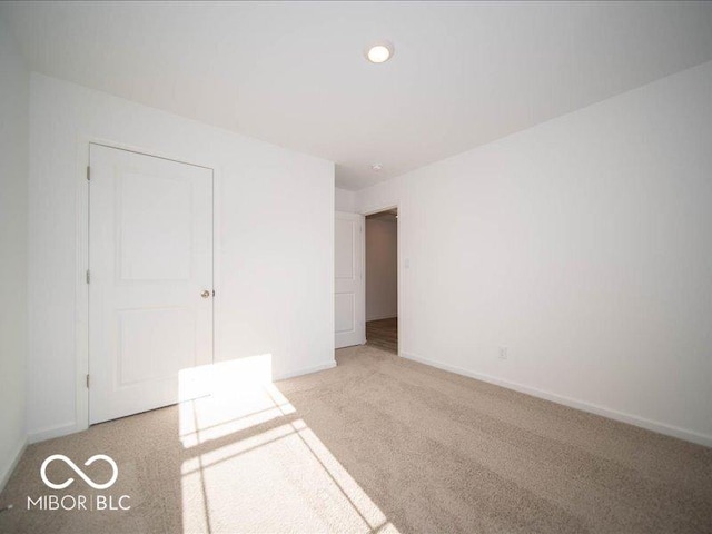 unfurnished bedroom featuring light colored carpet