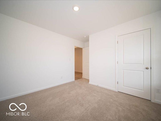 empty room featuring light colored carpet