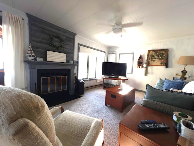 living room featuring a fireplace, ceiling fan, and light carpet