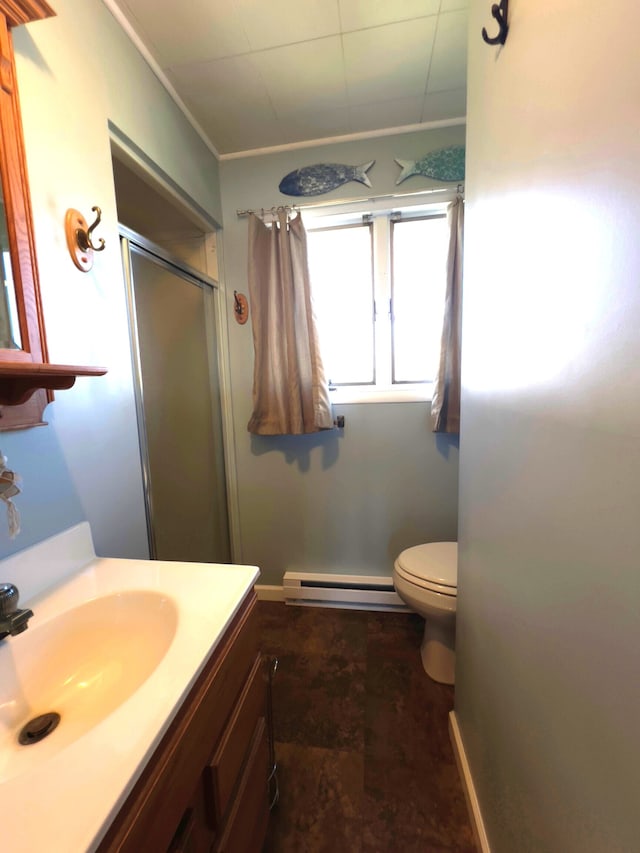 bathroom featuring tile flooring, a baseboard heating unit, toilet, a shower with shower door, and vanity