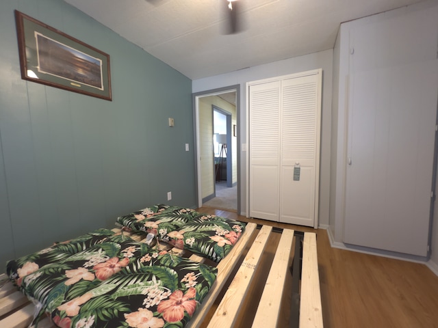 bedroom with a closet, ceiling fan, and light wood-type flooring