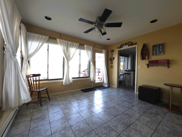 interior space featuring ceiling fan and baseboard heating