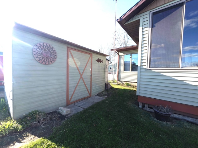 exterior space featuring a yard and an outdoor structure