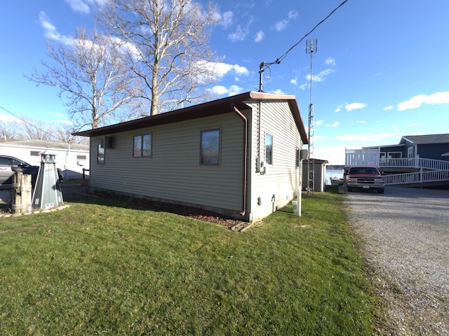 view of side of home with a lawn