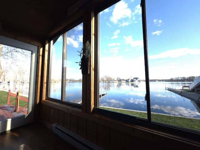 sunroom / solarium featuring a water view