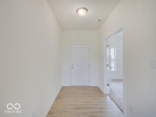 hall with light hardwood / wood-style flooring