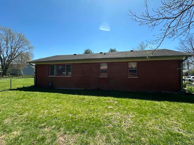 view of side of property with a lawn