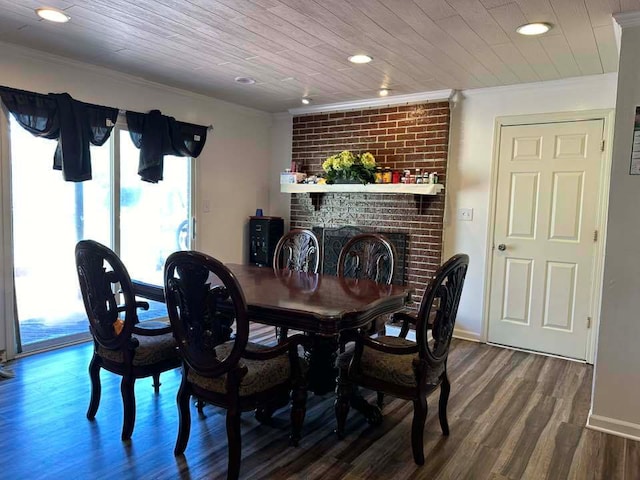 dining space featuring ornamental molding, wood-type flooring, and a fireplace