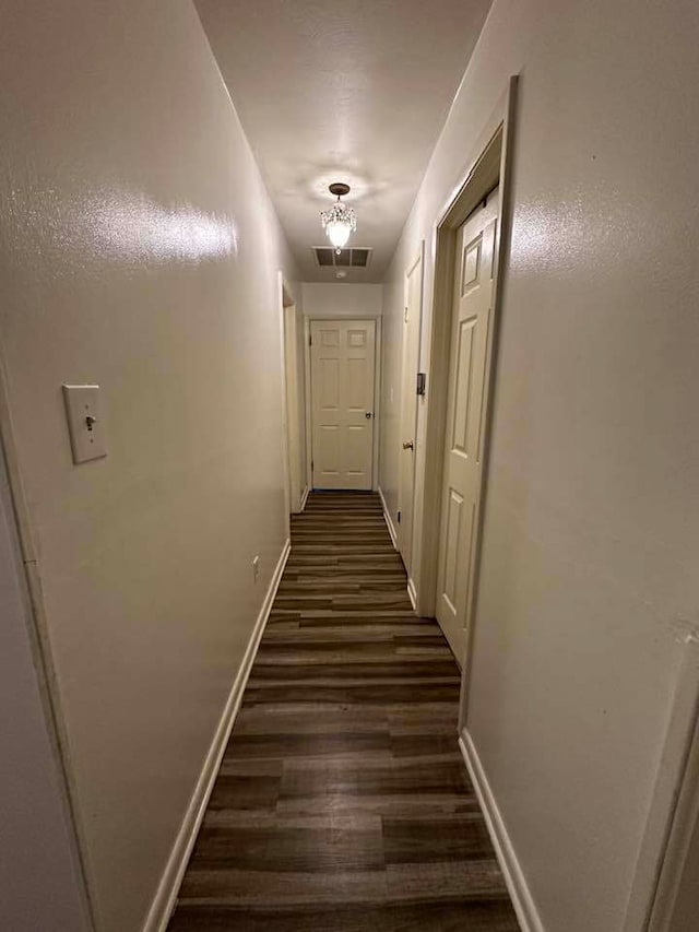 corridor featuring dark hardwood / wood-style flooring