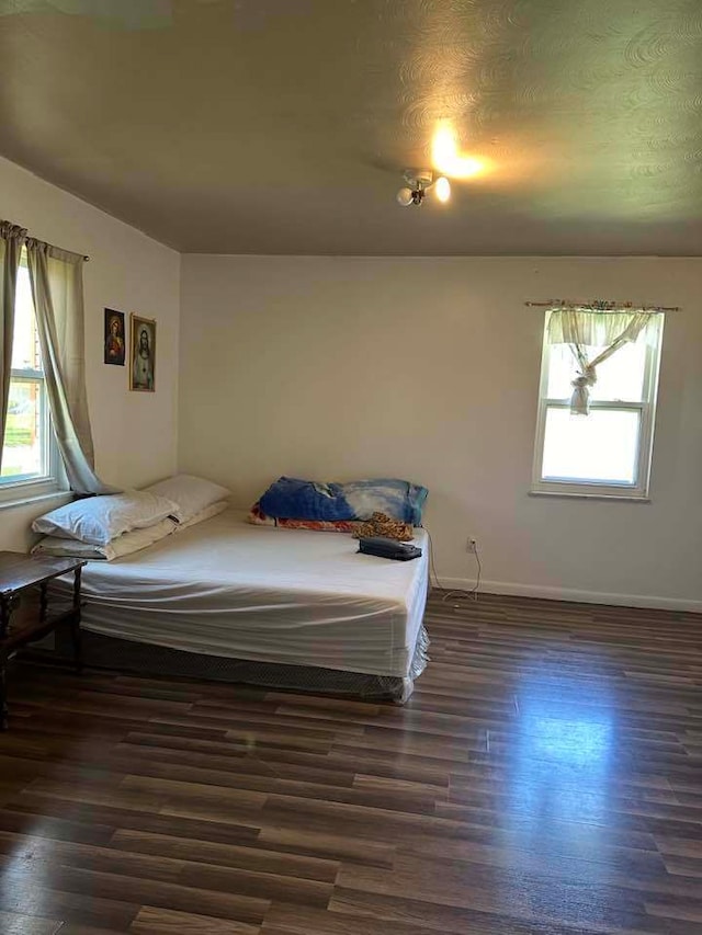 bedroom with dark wood-type flooring