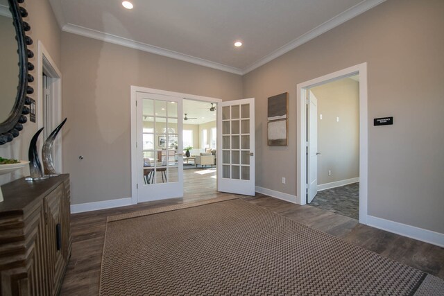 interior space featuring dark hardwood / wood-style floors, ornamental molding, and french doors