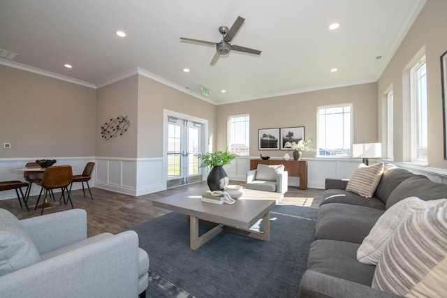 living room with ceiling fan, wood-type flooring, ornamental molding, and french doors